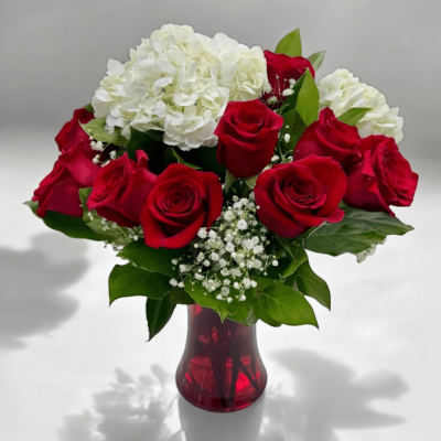 Close-up of red rose petals and hydrangea blooms