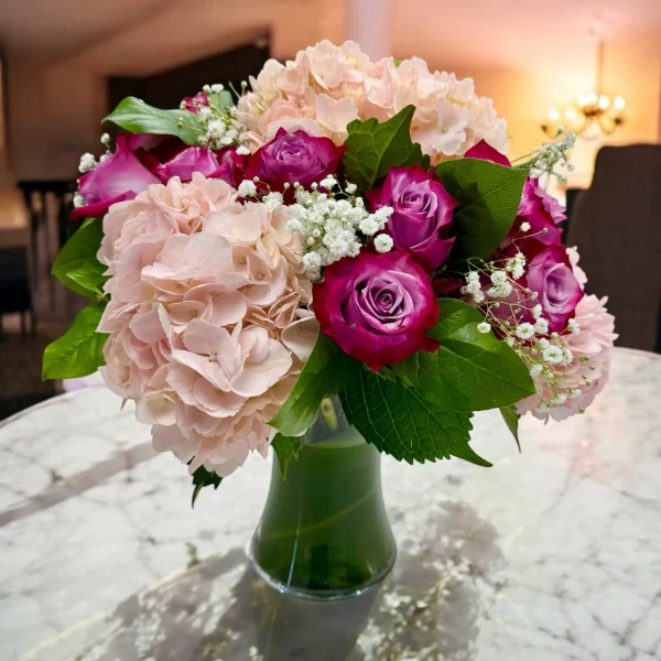 Beautiful vase of purple roses and pink hydrangea for local delivery