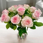 Hand-arranged pink roses in a clear vase