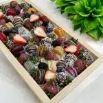 Decorative display of Chocolate Strawberry & Macaron Gift Tray, featuring fresh berries for an elegant presentation.