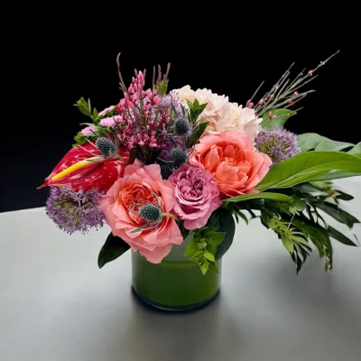 Soft-toned flowers arranged in a glass vase for a welcoming environment