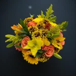 Yellow and orange mixed floral design photographed from above