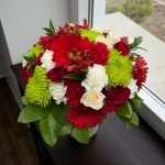 Bright holiday bouquet arranged for Christmas flower delivery