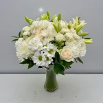 Soft white bouquet with lilies, roses, and daisies