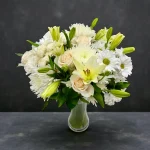 White mixed bouquet photographed against a dark background
