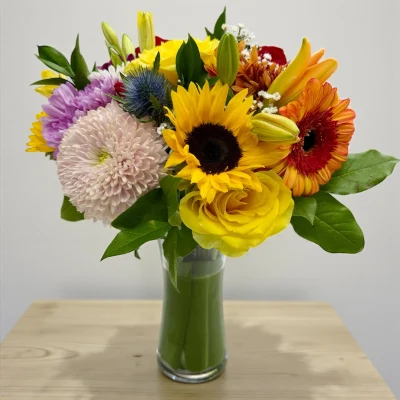Mixed blooms arranged for vase flower delivery service