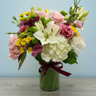 Mixed white and pink flowers in a NYC flower arrangement on a table