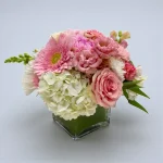 Soft pink bouquet arranged in a modern square vase