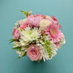 Soft pastel pink arrangement with roses, mums, and gerbera
