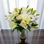 White mixed-flower bouquet displayed in a clean setting