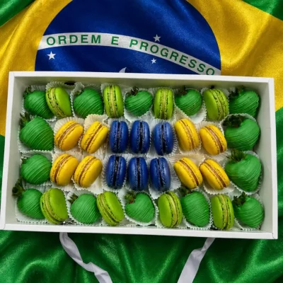 World Cup Brazil sweets box featuring chocolate dipped strawberries and macarons arranged in team colors