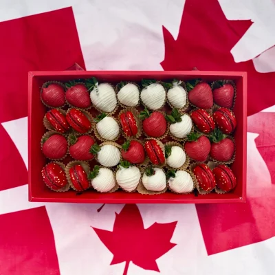 World Cup Canada sweets box featuring chocolate dipped strawberries and macarons arranged in team colors