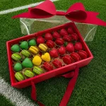 World Cup Portugal sweets box featuring chocolate dipped strawberries and macarons arranged in team colors