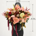 Grey silhouette holding The Fifth Avenue Statement flower arrangement, approximately 30 inches tall and 24 inches wide, for size comparison.