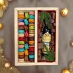 Christmas gourmet gift tray featuring assorted French macarons and chocolates in a divided wooden box