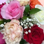 Colorful mixed rose arrangement with fresh greenery, handcrafted by WOW Bouquet florists in Maywood, New Jersey.