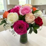 Assorted roses in a clear glass vase featuring colorful fresh blooms, available for local flower delivery in Bergen County, NJ.